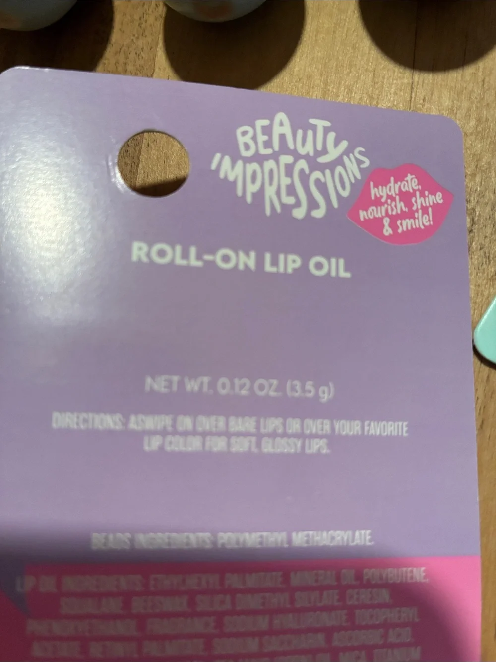Impressions Roll-On Lip Oil Duo in Pink and Purple Packaging